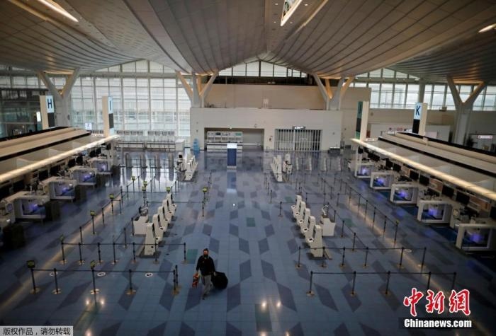 資料圖：日本東京，東京國際機場，一名乘客在國際航班航站樓的登機區(qū)。