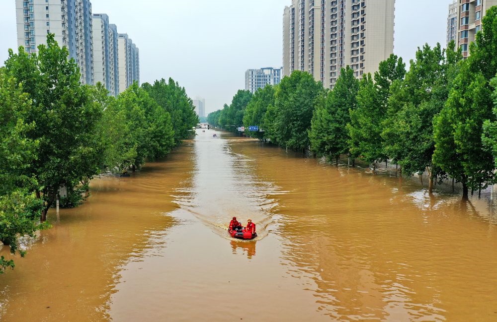 救援人員在河北省涿州市市區(qū)乘坐沖鋒舟前去轉(zhuǎn)移受災(zāi)群眾（8月2日攝，無人機(jī)照片）。新華社記者 牟宇 攝