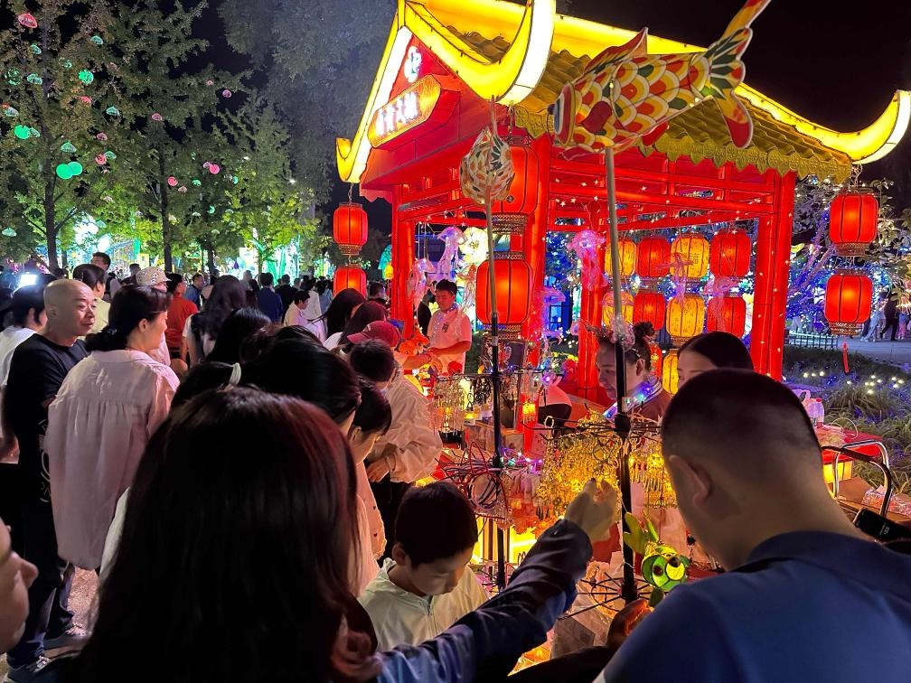 市民游客在2024年北京中秋國慶彩燈游園會上選購特色文創(chuàng)商品。新華社記者楊淑君 攝