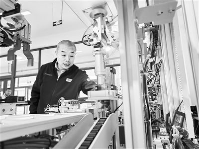 郭海青在檢查車床加工設(shè)備。 受訪者供圖